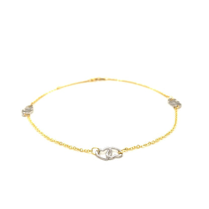 Tobillera con diseño de corazón entrelazado en oro bicolor de 14k
