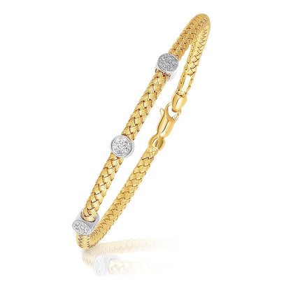 Brazalete tipo eslabón de oro bicolor de 14k con acentos de diamantes y diseño trenzado