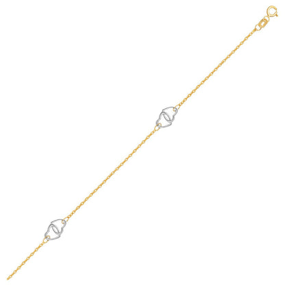 Tobillera con diseño de corazón entrelazado en oro bicolor de 14k