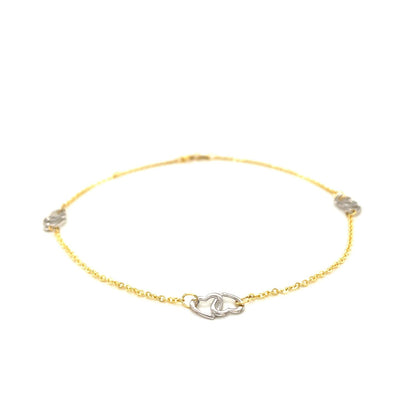 Tobillera con diseño de corazón entrelazado en oro bicolor de 14k