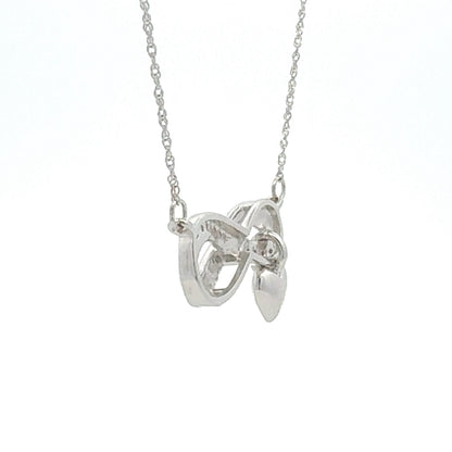 Colgante religioso de cruz con diamante de .04ct de plata de ley