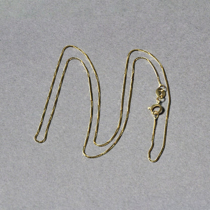 Cadena clásica de oro amarillo de 14k y 0.6mm