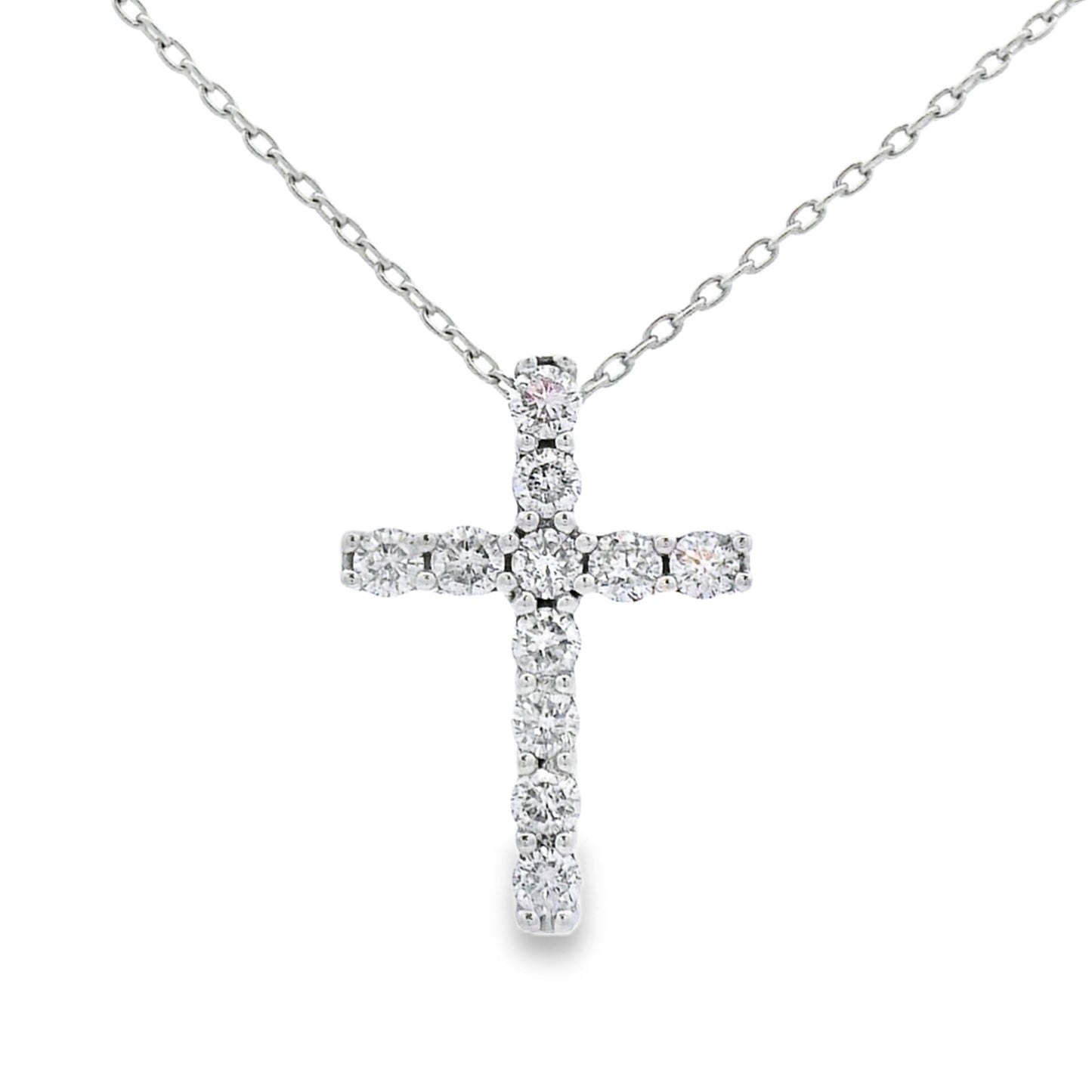 Colgante religioso de cruz con diamante de .35ct en oro blanco de 14K