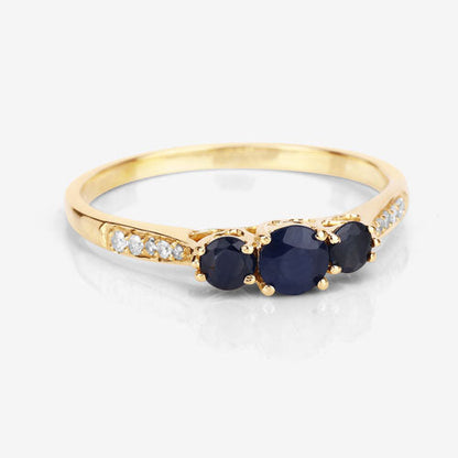 Anillo de oro amarillo de 14K con zafiro azul genuino de 0,56 quilates y diamantes blancos
